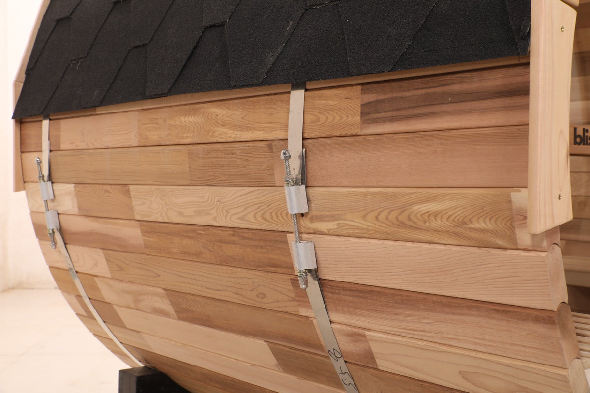 Wooden sauna with a black roof on a beige background