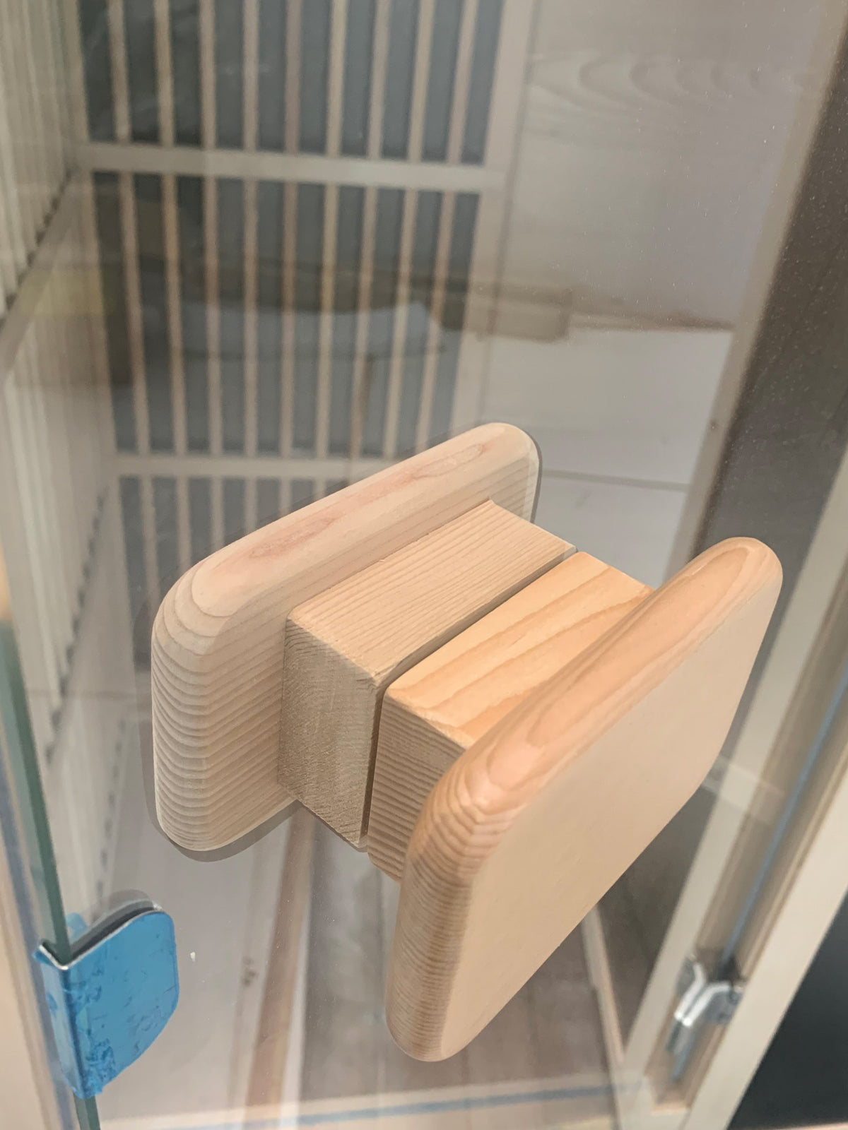 Wooden door handle on a glass door