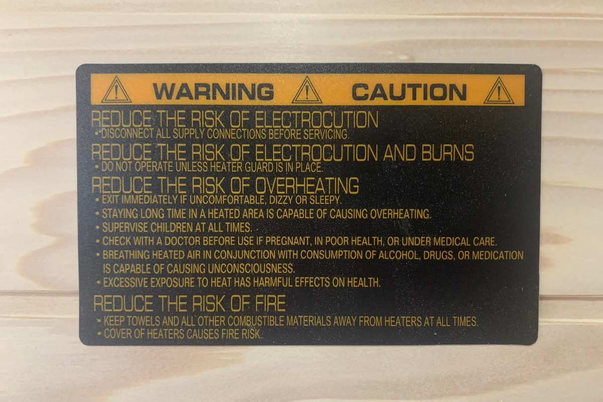Warning and caution label on a wooden background