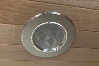 Round recessed light fixture on a wooden ceiling
