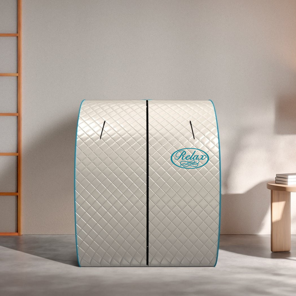 A quilted dome-shaped relaxation sauna tent with a diamond pattern, light gray exterior, and turquoise blue trim. The brand name 'Relax' is printed in a turquoise oval logo on the front.