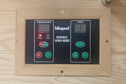 Control panel for a Blisspod infrared sauna room with digital displays and buttons.