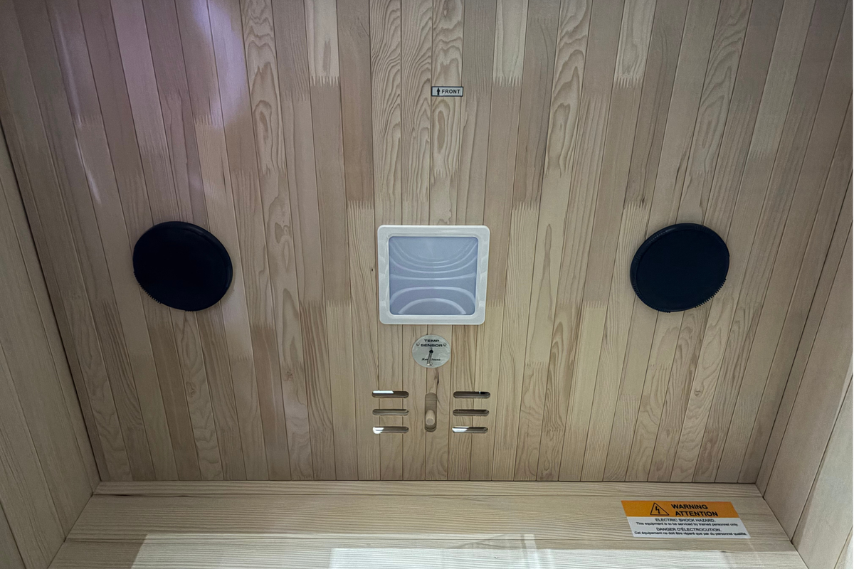 Wooden sauna with control panel and speakers