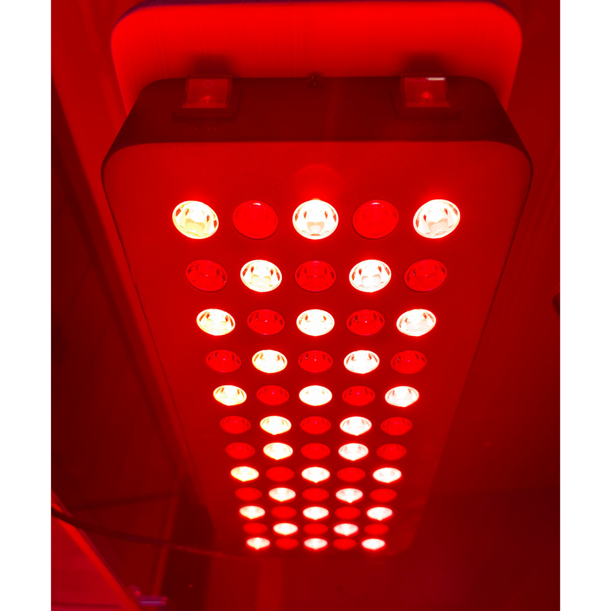 Red LED light panel with multiple small lights on a white background