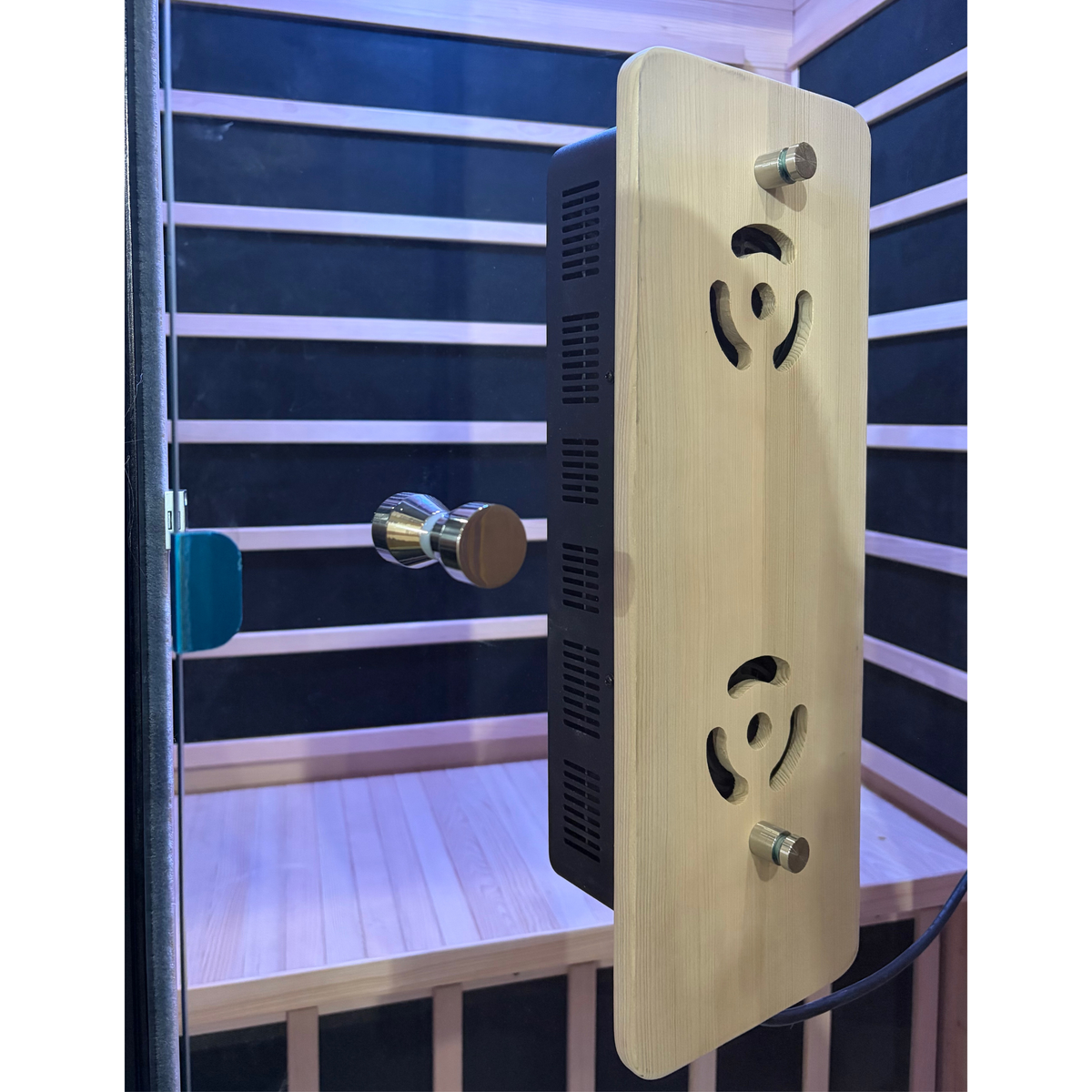 Wooden sauna control panel with electronic components on a sauna interior background