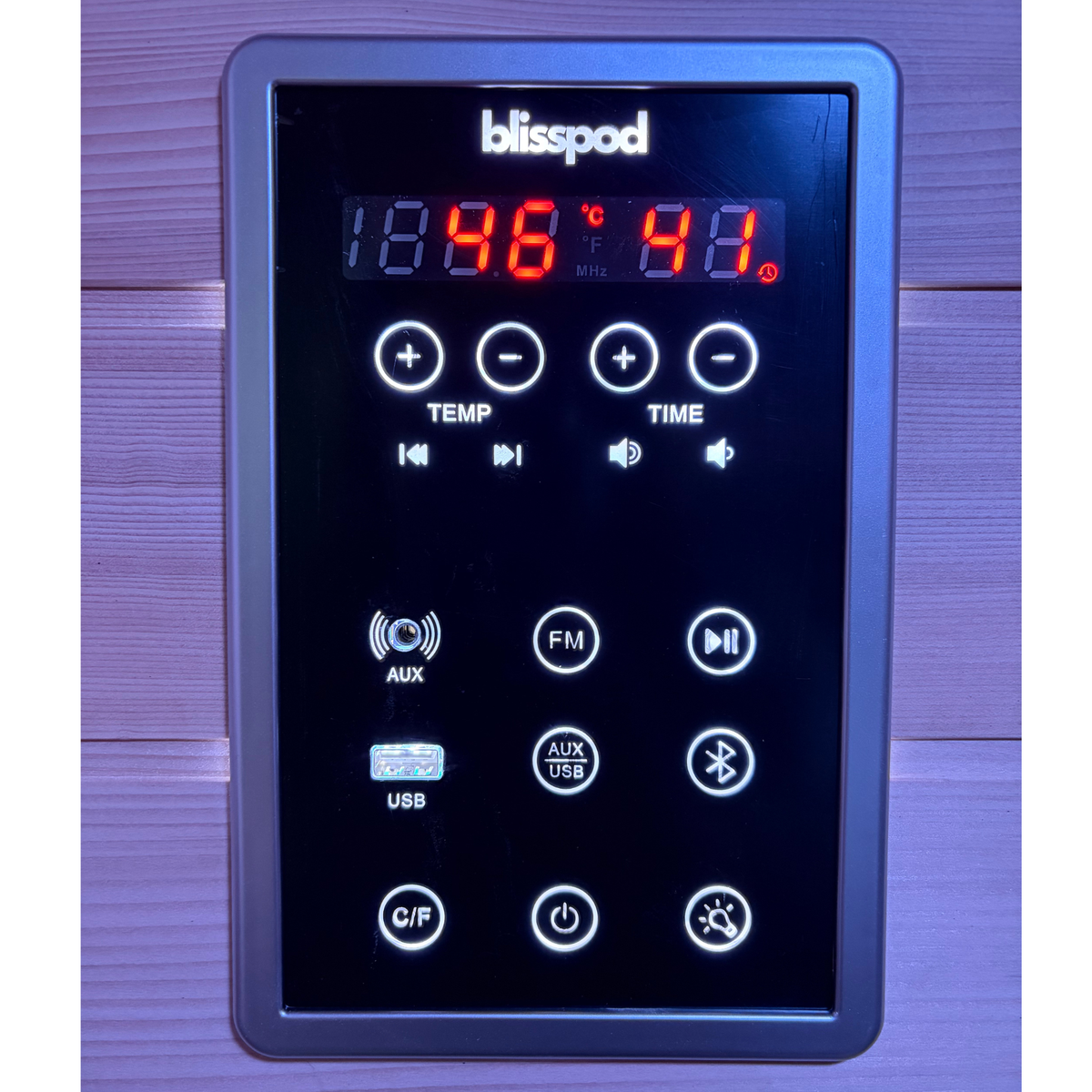 Control panel of a blisspod with digital display and buttons on a wooden background