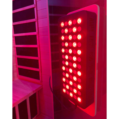 Red light therapy panel in a room with pink lighting
