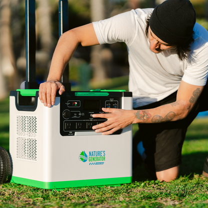 Person interacting with a portable power station labeled 'Nature's Generator' outdoors.