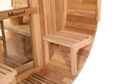 wooden exterior of a barrel sauna with a one person seat.