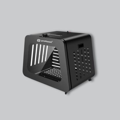 A black Protocol pet carrier with ventilation slots and a clear front door, shown on a solid gray background.